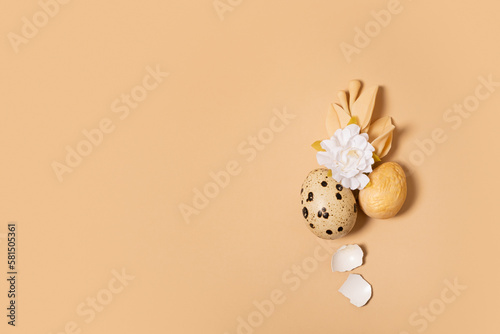Monochrome flat lay Easter eggs minimalistic composition decoration with twigs and flower. Easter still life golden beige