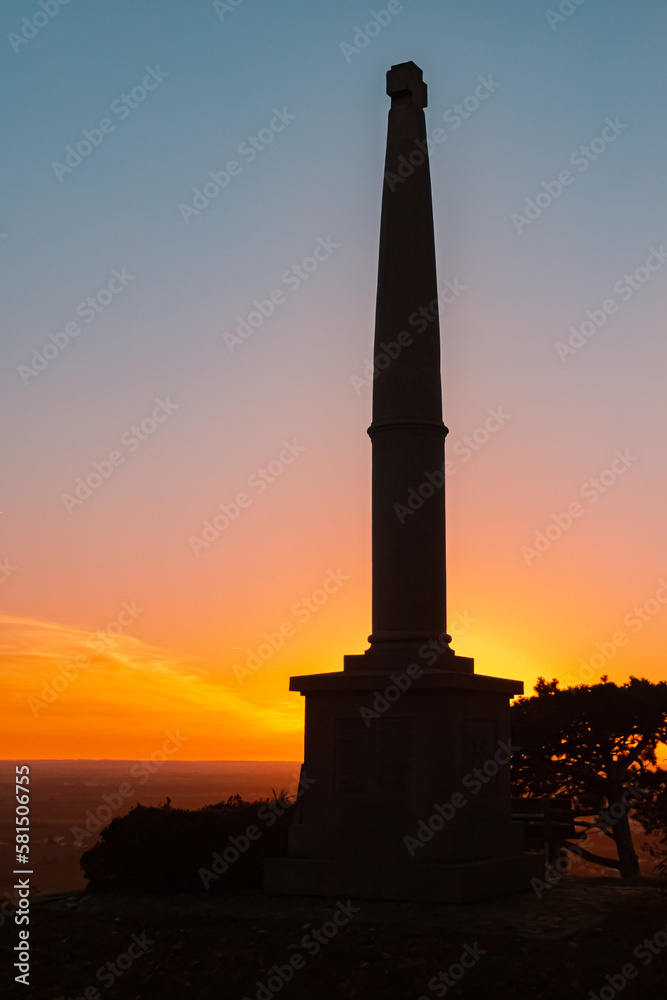 Sunset with a silhouette of a war memorial at Mount Bogenberg, Bogen, Danube, Bavaria, Germany