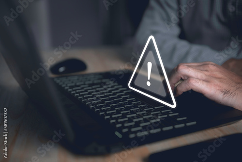 Computer hack warning,System hacked warning alert on notebook (Laptop),cyber security concept,The danger of malware viruses,ransomware virus,triangle caution warning sign for notification error