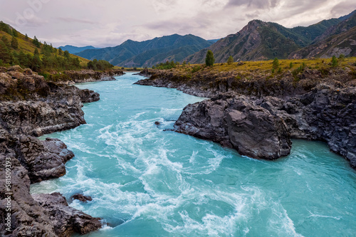 Popular landmark suspension Oroktoysky bridge over Katun river in valley of Altai Mountains, aerial top view. Landscape Chemal Siberia, Russia