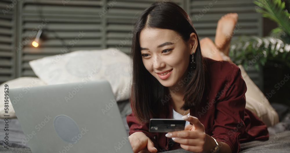 young chinese woman using laptop and holding credit card, online shopping concept Donate Charity Give Help Offering Volunteer Concept young chinese woman using laptop and holding credit card, online shopping concept Donate Charity Give Help Offering Volunteer Concept
