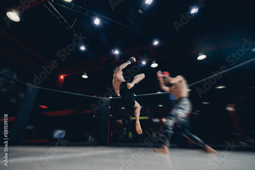 MMA Boxers fighters in fights without rules in ring octagon, motion blur, dark background © Parilov