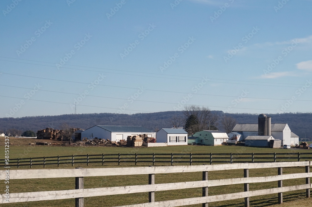 Farm Scene with White Fence and Buildings, Blue Sky, Green Farm Scene with White Fence and Buildings, Blue Sky, Green