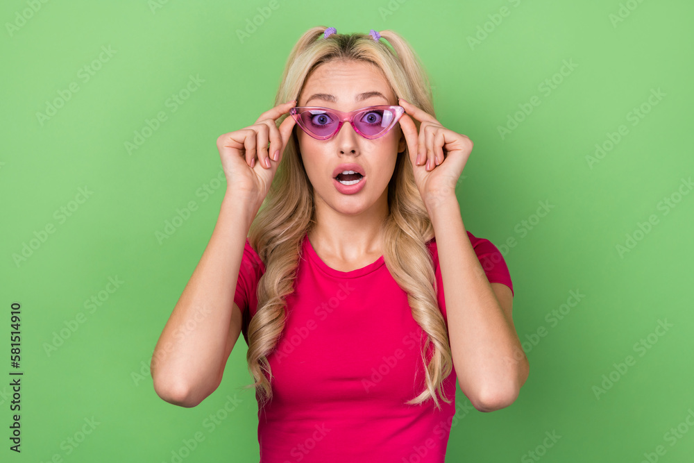 Photo of funky impressed lady dressed pink t-shirt arms glasses open mouth isolated green color background Photo of funky impressed lady dressed pink t-shirt arms glasses open mouth isolated green color background