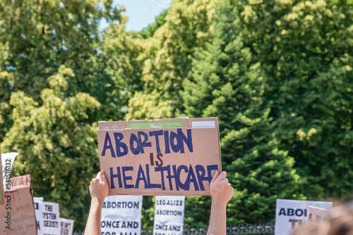 Protests holding pro-abortion signs at demonstration in response to the Supreme Court Dobbs ruling overturning Roe v. Wade.