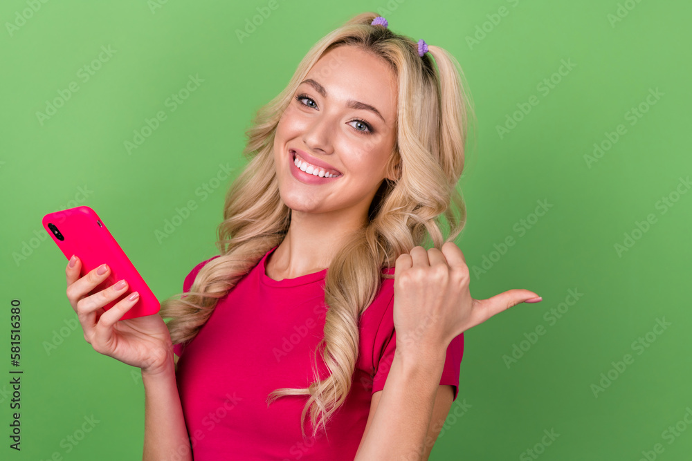 Photo of funny pretty woman wear pink top typing modern gadget thumb empty space isolated green color background Photo of funny pretty woman wear pink top typing modern gadget thumb empty space isolated green color background