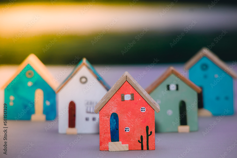Mini wooden house black background using as business financial and property real estate, saving , investment concept Mini wooden house black background using as business financial and property real estate, saving , investment concept