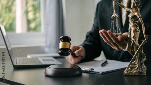 Obraz na płótnie Holding gavel, Lawyers and legal requirements and bribery in adjudicating and adjudicating litigation cases