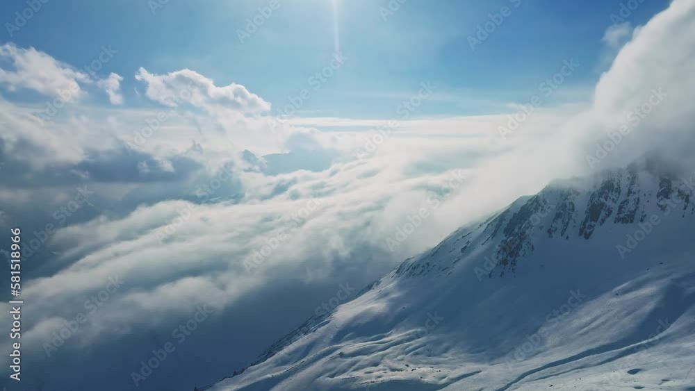 Alpine landscape with peaks covered by snow and clouds. Magical clouds ...