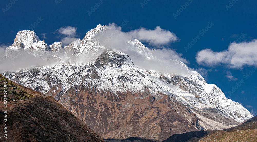 Fototapeta premium Larkya Peak, 6249 m, as seen from Manaslu Circuit trail to Larkya Phedi camp from Samdo village, Manaslu Himal range, Gorkha district, Nepal Himalayas, Nepal