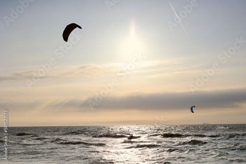 Kitesurfing in the evening at a Dutch beach on a windy spring day. The north sea near Wassenaar, The Netherlands. 