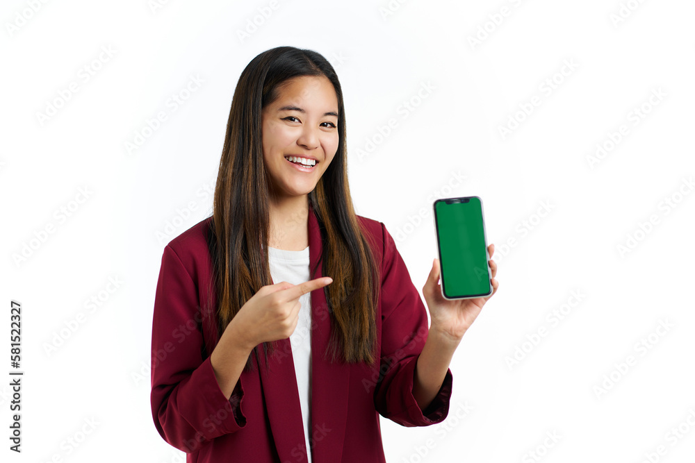 a happy smiling young asian woman pointing at the green screen mobile phone a happy smiling young asian woman pointing at the green screen mobile phone