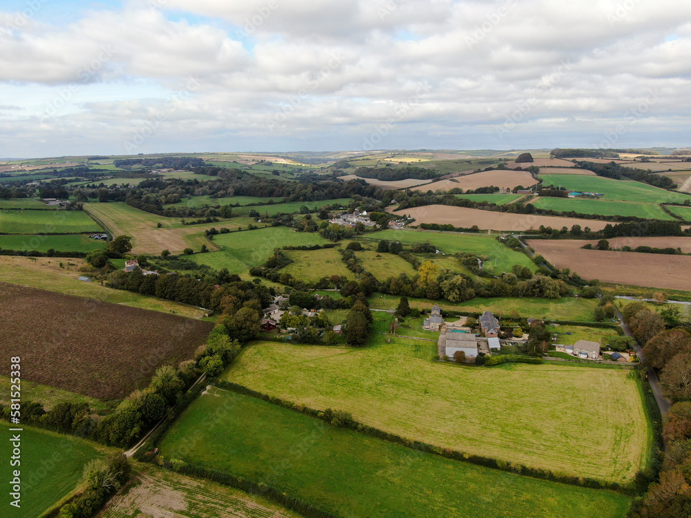 An aerial view of some patchwork rolling landscape with a mosaic of fields and hedges