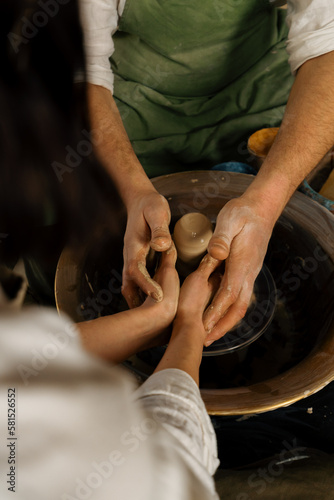 Pottery workshop a potter works with a potter's wheel a product made of clay a potter conducts a master class