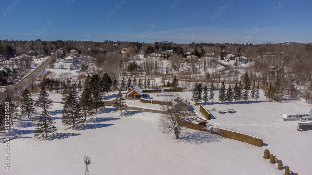 Aerial view of the Canadian countryside in Quebec near a maple grove in spring.