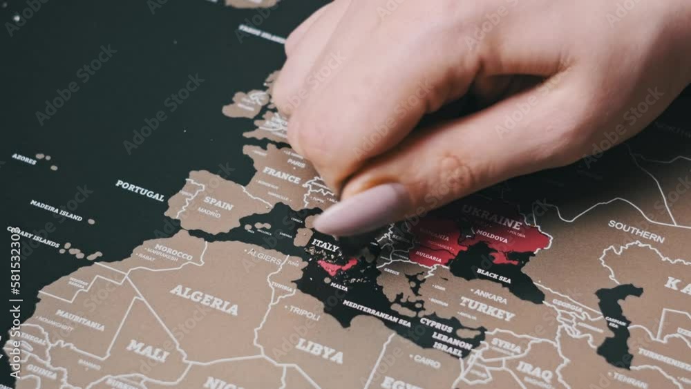 Female Hand Scratching country of Italy on the Surface of Scratch World