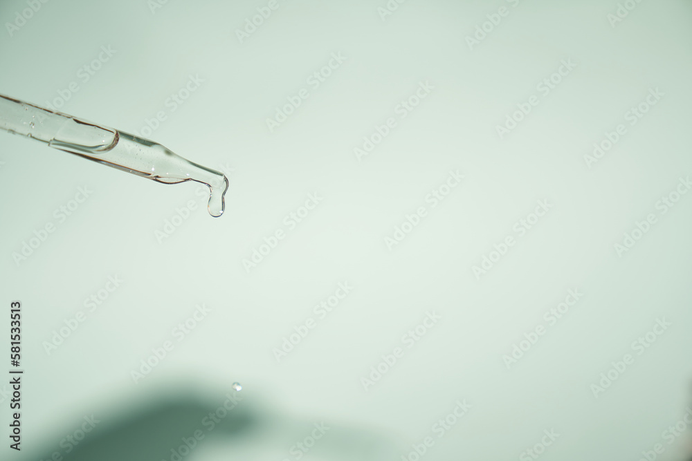 An essence pipette with a place to copy. Natural organic cosmetics. The concept of body care.Pipette with a dose of oil or liquid hyaluronic acid on a light background with a shadow.High quality photo An essence pipette with a place to copy. Natural organic cosmetics. The concept of body care.Pipette with a dose of oil or liquid hyaluronic acid on a light background with a shadow.High quality photo