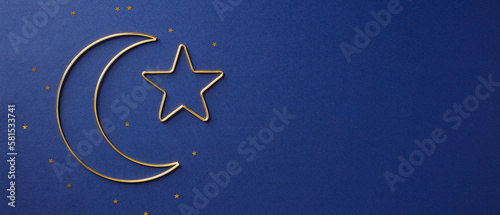 Golden Islamic star and crescent moon on dark blue background. Ramadan Kareem banner template. photo