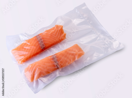 Salmon slices in vacuum packed sealed for sous vide cooking on white background photo