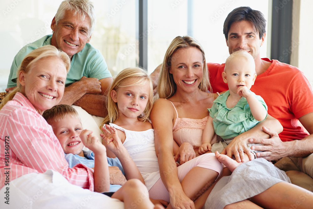 An abundance of love. Portrait of a loving multi-generational family sitting together on a sofa at home. An abundance of love. Portrait of a loving multi-generational family sitting together on a sofa at home.