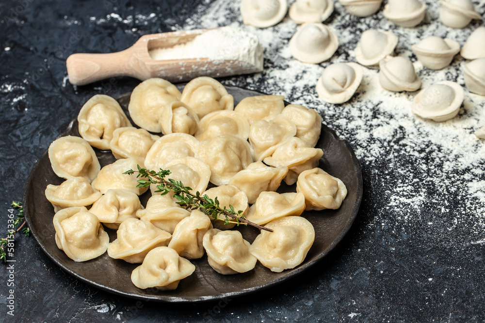 Traditional pelmeni, ravioli, dumplings with meat on black plate. Restaurant menu, dieting, cookbook recipe top view Traditional pelmeni, ravioli, dumplings with meat on black plate. Restaurant menu, dieting, cookbook recipe top view