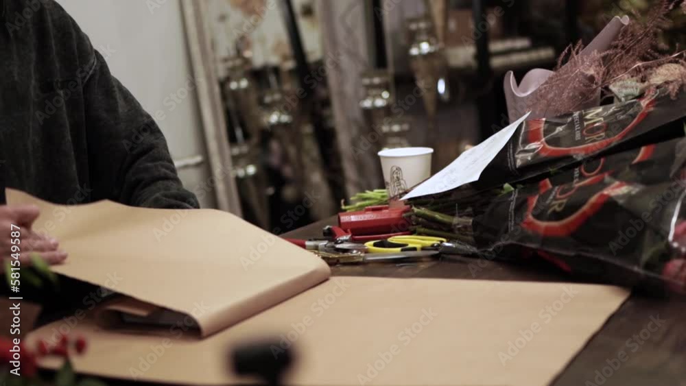 Girl wrapping the book in craft paper for gift Girl wrapping the book in craft paper for gift