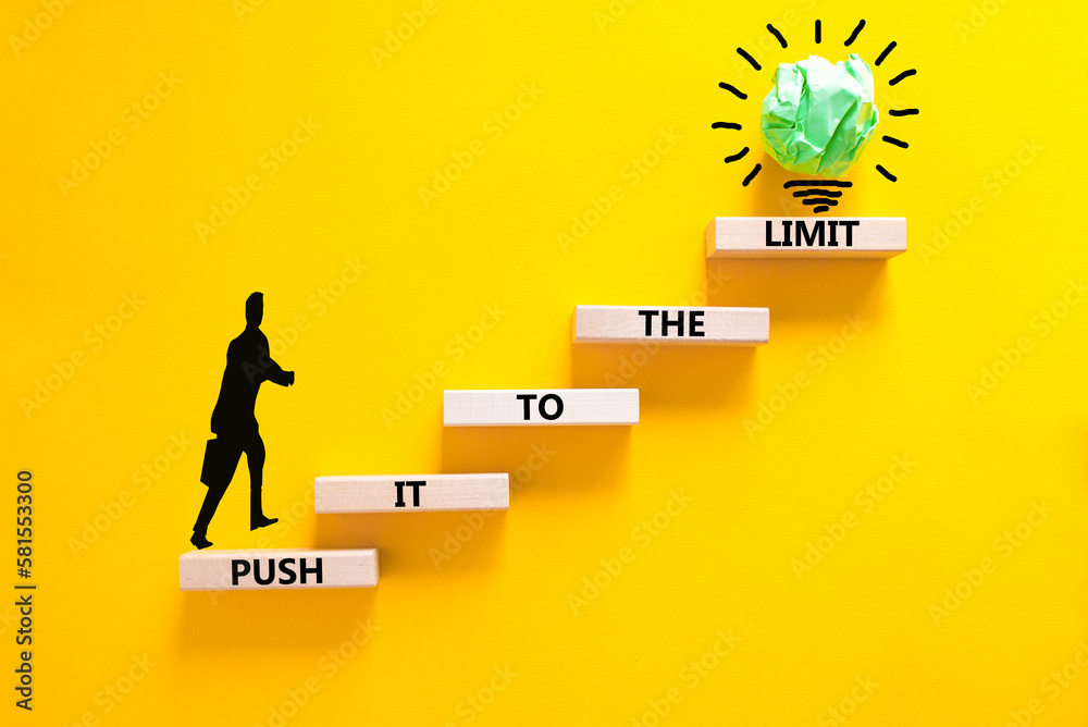 Push it to the limit symbol. Concept words Push it to the limit on wooden blocks. Beautiful yellow table yellow background. Businessman icon. Business push it to the limit concept. Copy space.