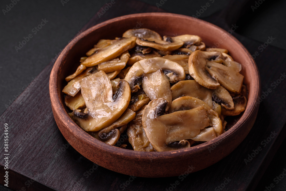 Fried or stewed champignon mushrooms in the form of slices with onions Fried or stewed champignon mushrooms in the form of slices with onions