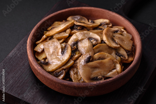 Fried or stewed champignon mushrooms in the form of slices with onions