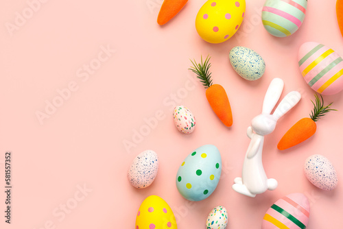 Composition with colorful easter eggs,easter bunny and carrots with copy space for text