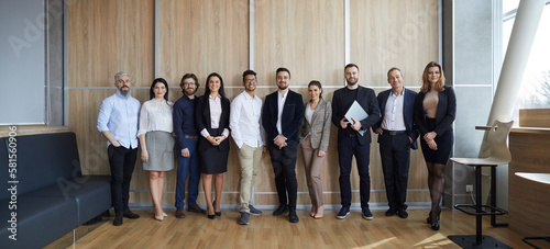 Banner narrow shot of successful diverse businesspeople in row pose in office together. Wide portrait of smiling multiracial company employee team show unity and leadership at workplace.