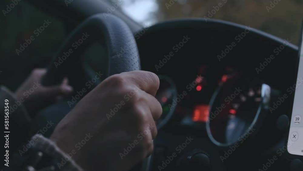 Female hands driver on steering wheel, woman driving the car by road at night , slow motion. Female hands driver on steering wheel, woman driving the car by road at night , slow motion.