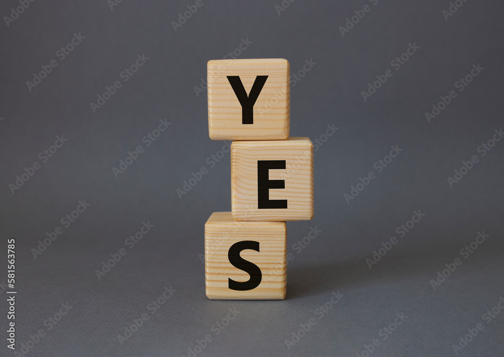 Yes symbol. Wooden blocks with word yes. Beautiful grey background. Business and yes concept. Copy space. Yes symbol. Wooden blocks with word yes. Beautiful grey background. Business and yes concept. Copy space.