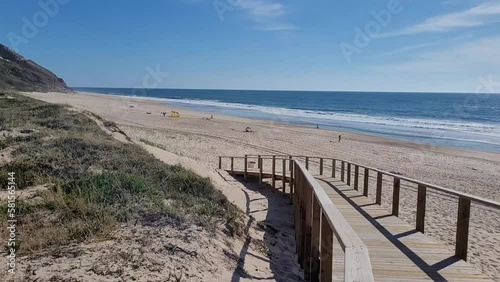 Wooden walkway leading to beautiful sandy beach in portugal