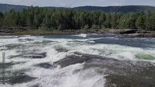 Raging river leading through mountain landscape in Norway.