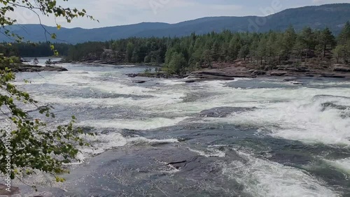 Raging river leading through mountain landscape in Norway.