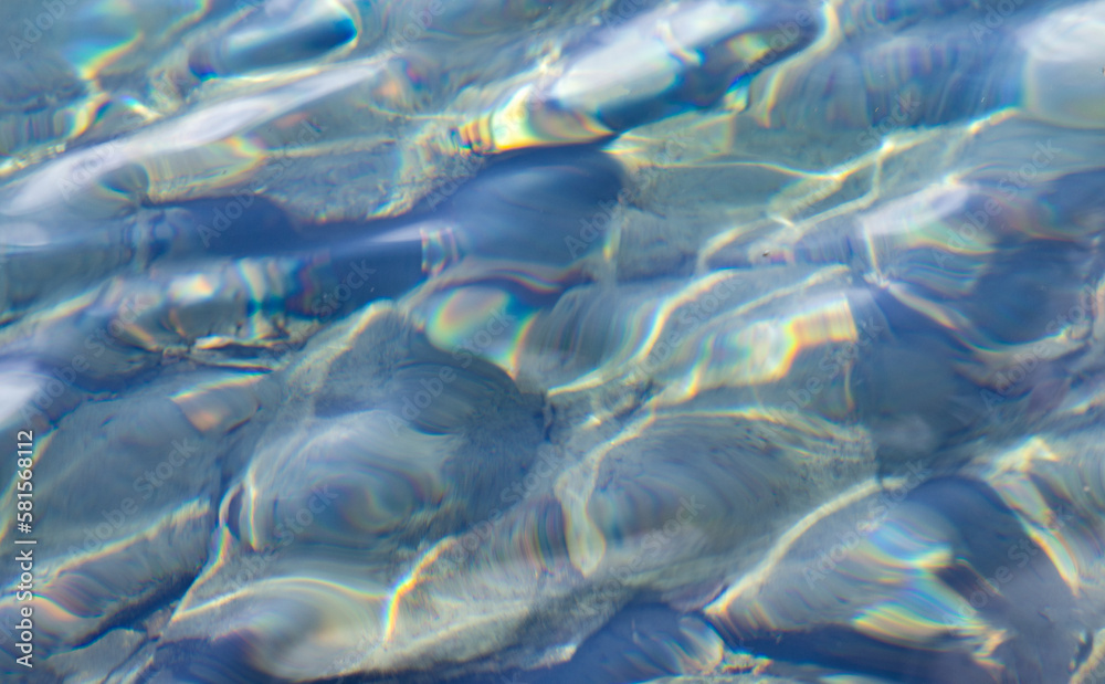 Shining stone pebbles underwater. Under clear turquoise water across a pebble creek Shining stone pebbles underwater. Under clear turquoise water across a pebble creek