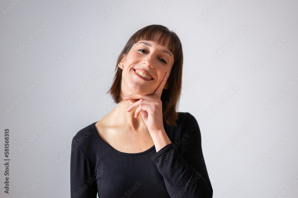 Portrait of a girl on white background. Brown short hair girl.  Girl resting her head on one hand