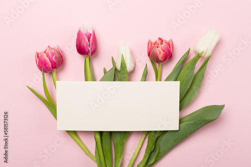 Fototapeta Naklejka Na Ścianę i Meble -  Bright tulips on color background, top view. Greeting card mockup