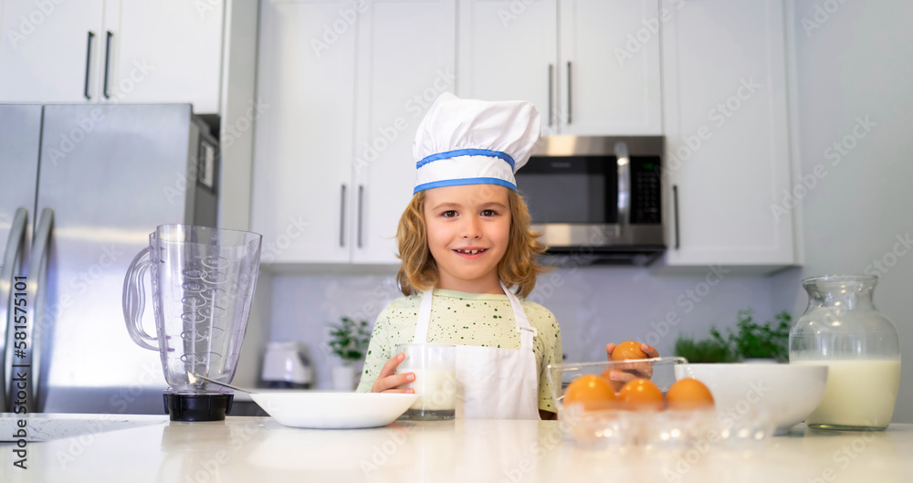 Child in chef hat and apron preparing food in the kitchen. Cooking children. Child boy with apron and chef hat preparing a healthy meal in the kitchen. Cooking process. Child in chef hat and apron preparing food in the kitchen. Cooking children. Child boy with apron and chef hat preparing a healthy meal in the kitchen. Cooking process.