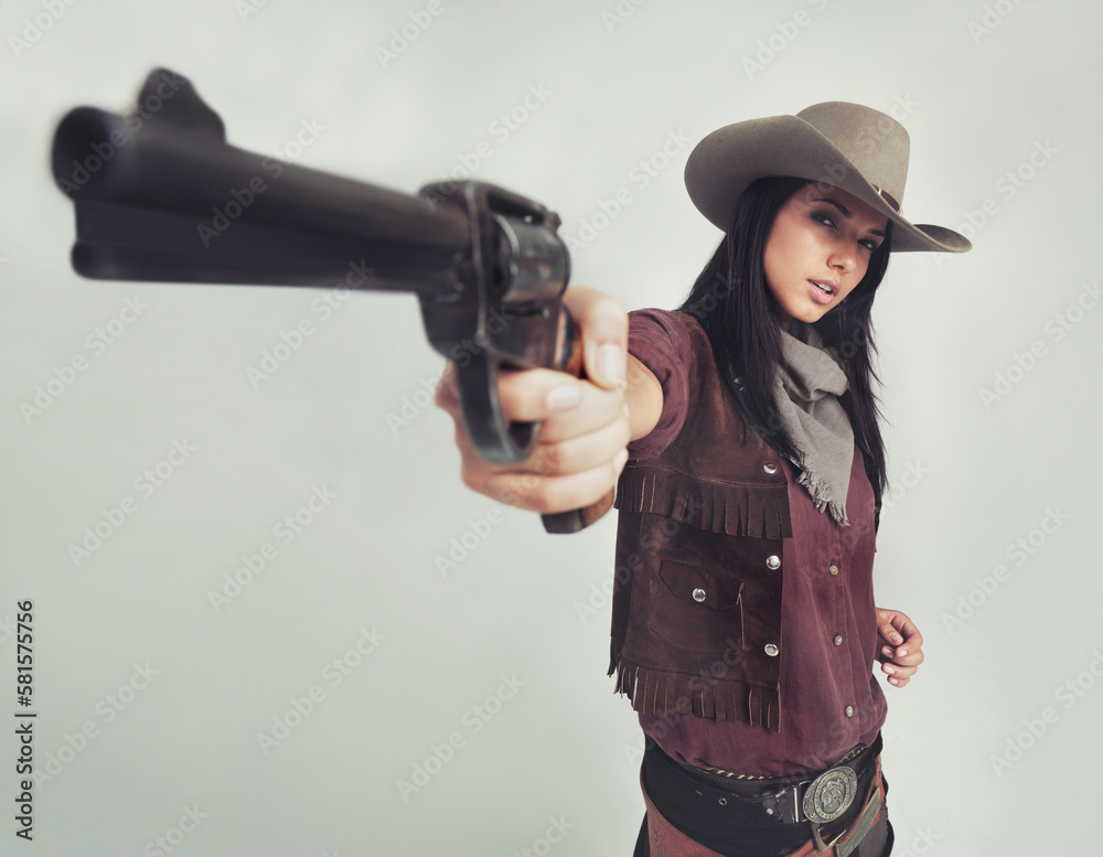 Im the sheriff around these parts...Full-length shot of an attractive young woman in cowboy attire. Im the sheriff around these parts...Full-length shot of an attractive young woman in cowboy attire.