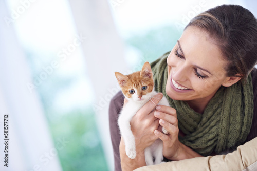 Happy is the one who owns a cat. an attractive young woman holding a kitten.