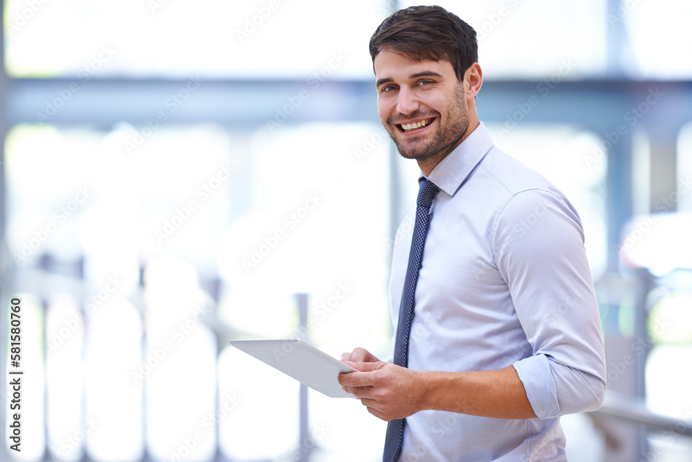 Fototapeta premium The modern work desk. A young professional businessman holding a digital tablet.