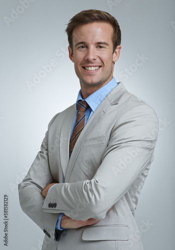 Always professional. A confident young businessman standing with his arms folded.