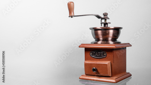 Traditional wooden coffee mill grinder over white background