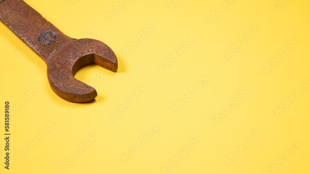 Old wrenches on a yellow background metal and rusty wrench isolated on yellow background.An old rusty wrench on a white background. Vintage wrench close-up.