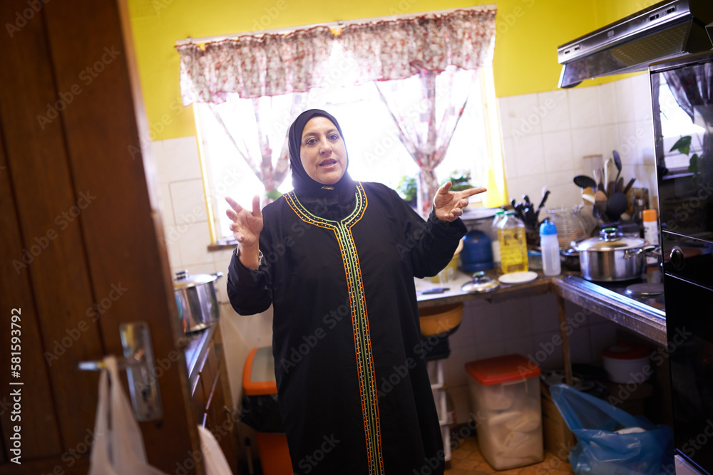 This is a place of deliciousness. a mature muslim woman in her kitchen.
