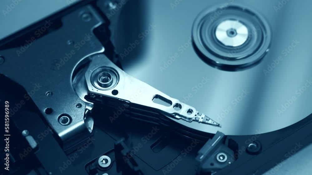 close-up view of working, opened hard disk drive. Blue color tones