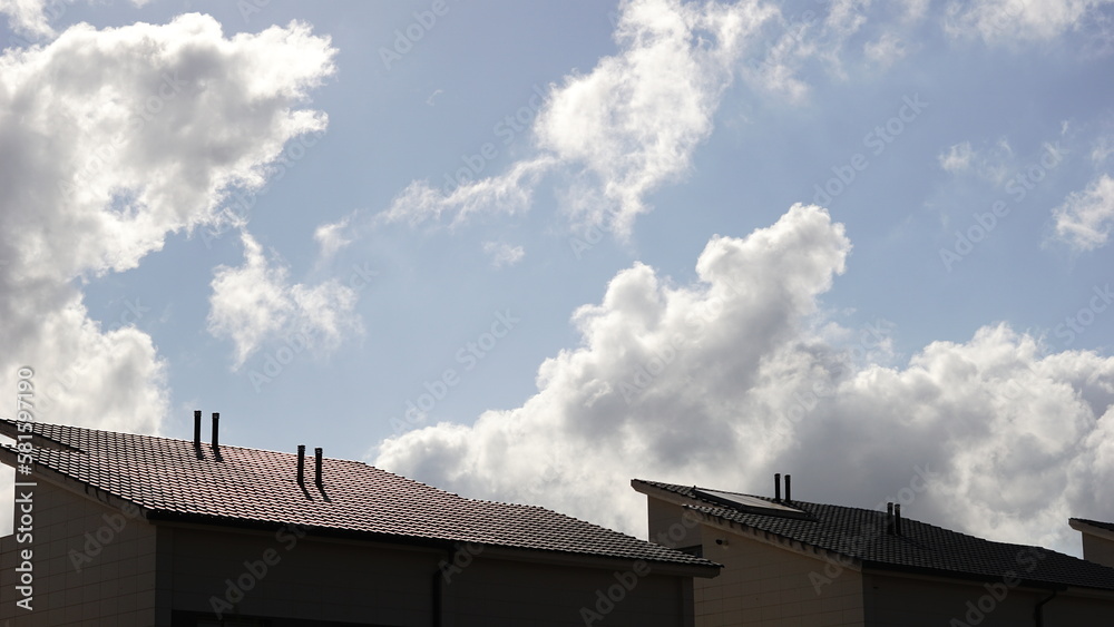 house roofs against cloudy sky
