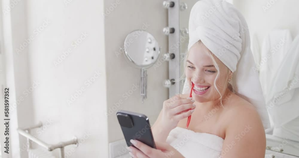 Happy caucasian plus size woman using smartphone and brushing teeth in slow motion Happy caucasian plus size woman using smartphone and brushing teeth in slow motion